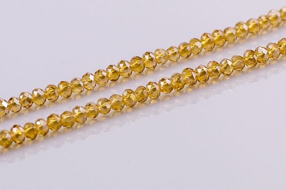 Хрусталь бусины 4 мм, ~140 шт / нить, на нитке, светло-золотой с напылением, прозрачный.
